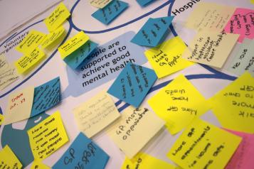 A table filled with post-it notes containing feedback