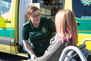 Ambulance driver with patient in wheelchair